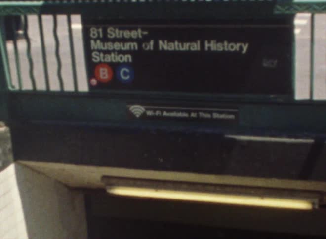 Steps on a city sidewalk lead to a subway station