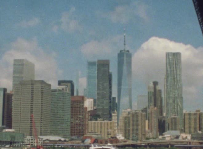 A boat sails past the city