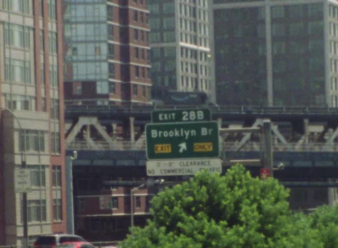 Cars are driving through a downtown city during spring