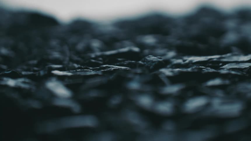 Rain is falling on stones and rocks outside