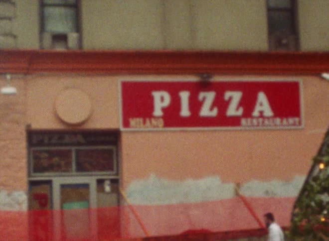 Exterior view of pizza restaurant with sign