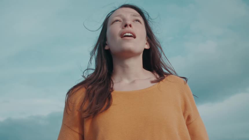 A woman takes deep breaths as she has a look of awe on her face