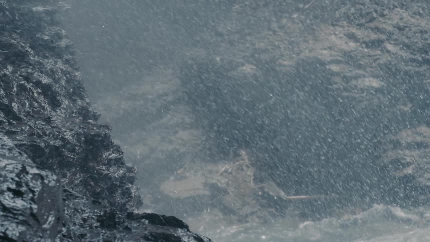 Water crashing up against large rocks