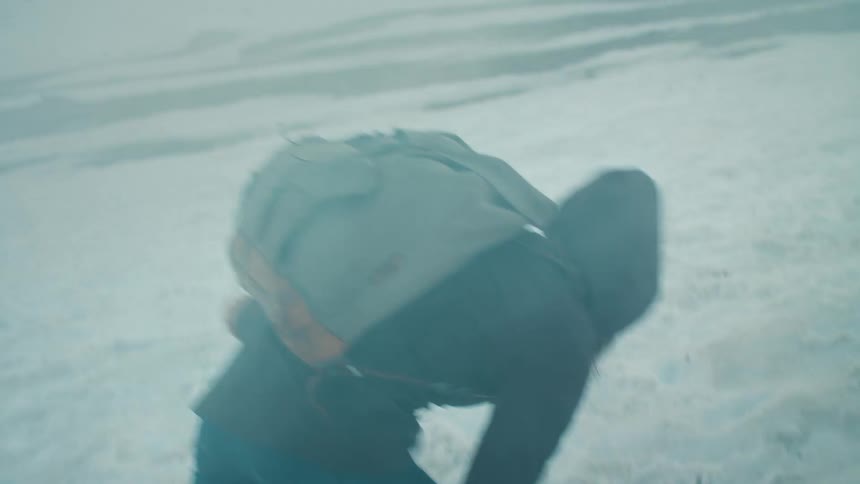 A hiker falling in snow on the mountain