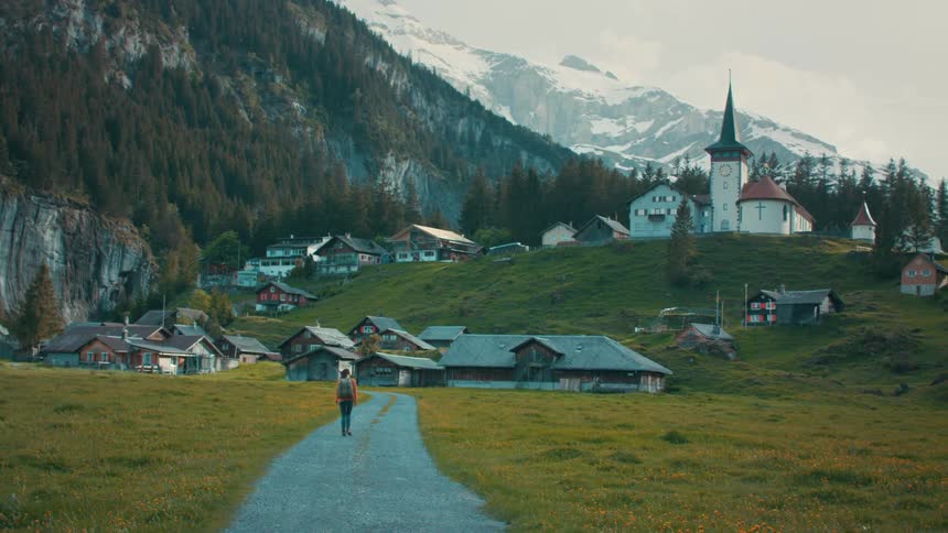 A woman is walking towards the small town