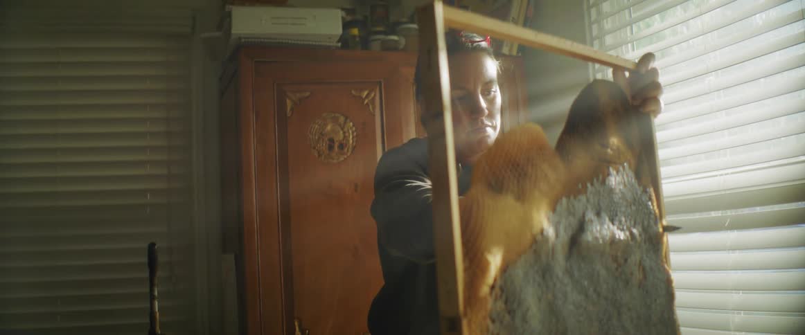 A woman using a knife to cut an object