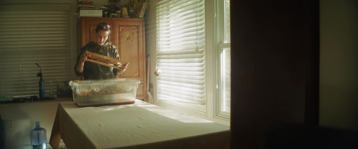 A young white woman is standing inside of her house