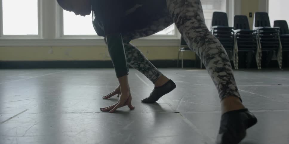 A woman stretches in a room