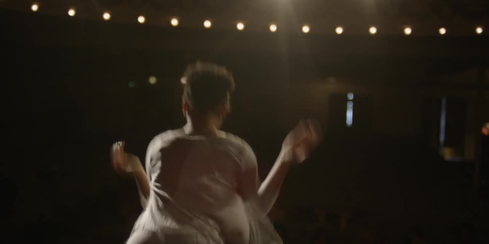 Woman dancing on a stage in a theatre