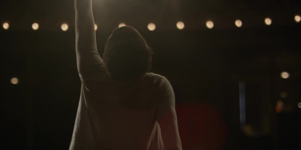 A woman dances on a stage