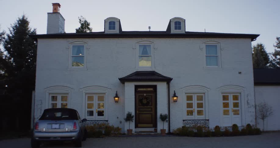 The front part of house before gray sports car