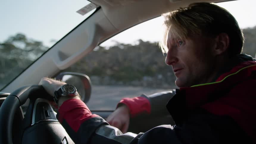 A man is sitting in his car