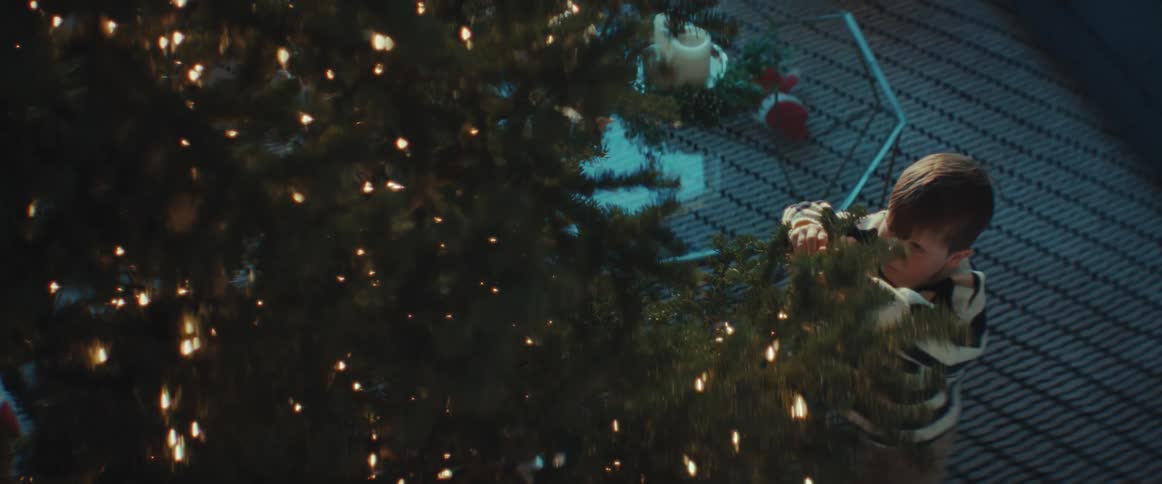 Children decorate christmas tree in room