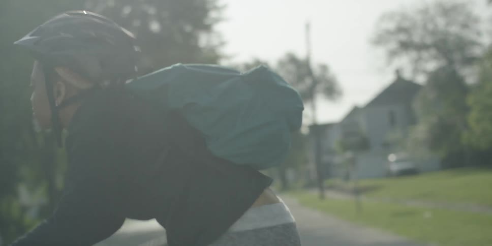 A woman is riding a bike on a neighborhood street