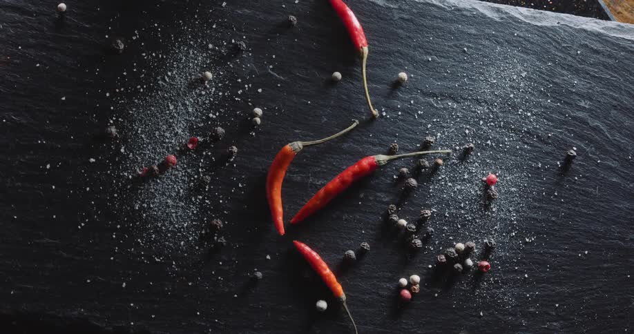 Red peppers and spices are on the counter