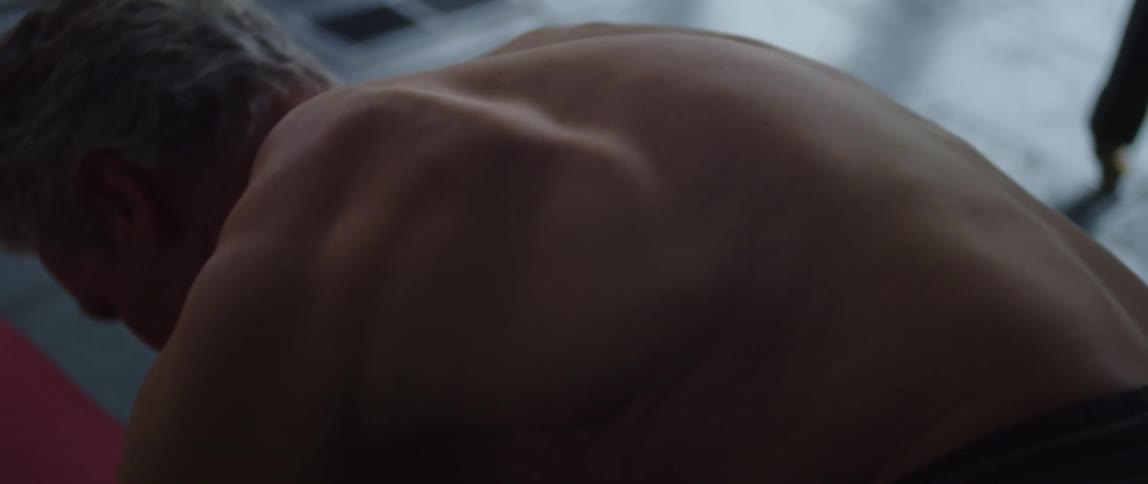 A man is on the floor doing push ups on an exercise mat