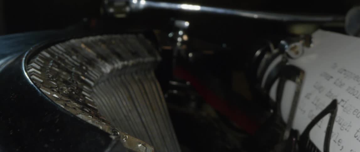 A document is typed on a vintage style typewriter