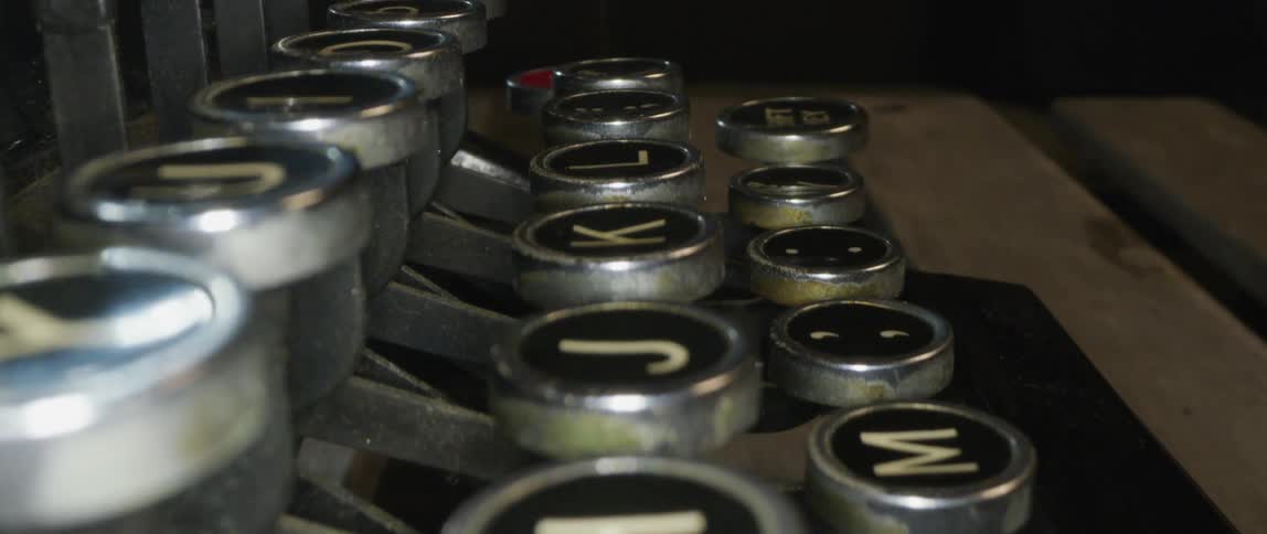 Letters and symbols fill round keys on manual typewriter