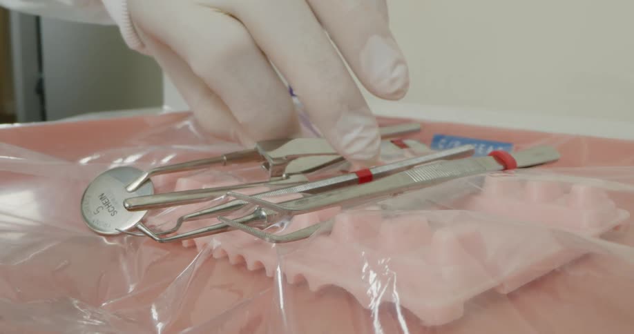 A dentist is placing his tools down