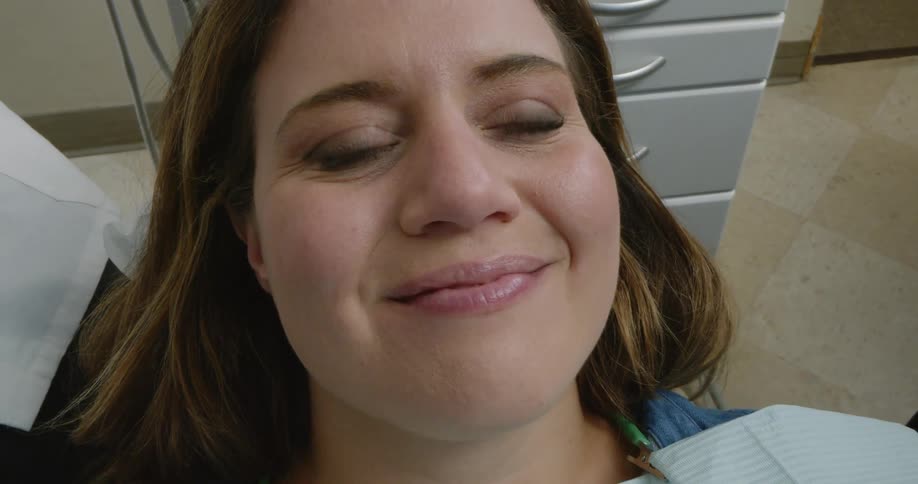 A patient smiles after being examined by a nurse