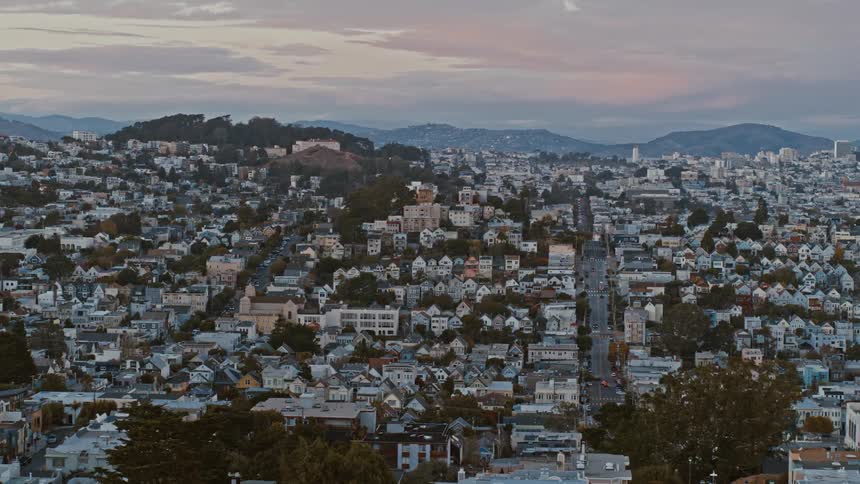 Aerial view of a city during sunset is displayed