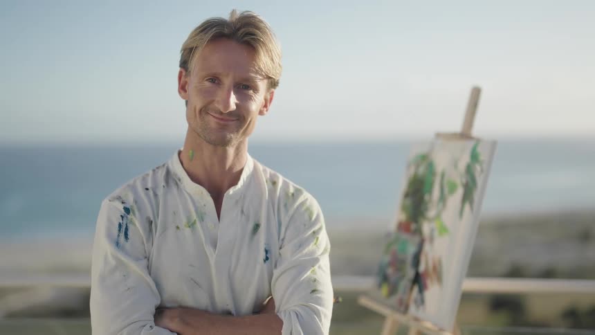 A portrait of an artist standing outdoors