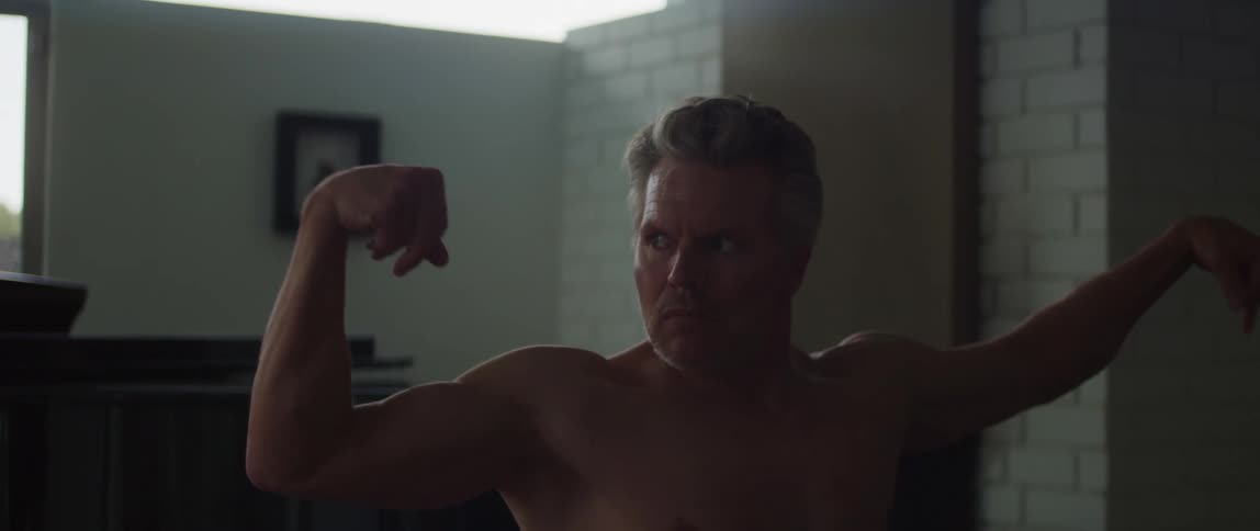 A man is stretching his arms into a yoga pose