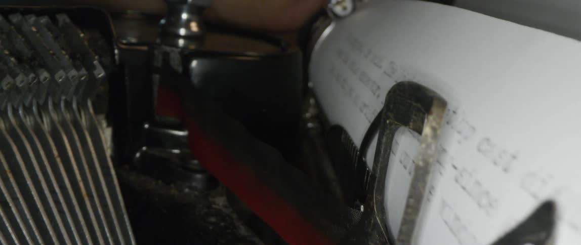 A vintage typewriter with paper moving in it