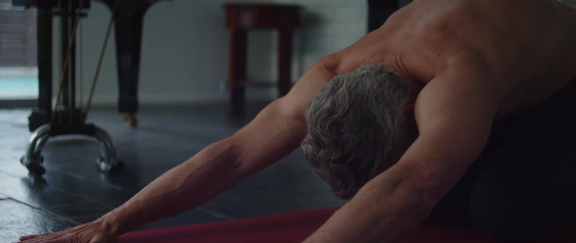 A man stretching in a room
