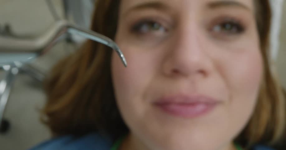 A woman getting her teeth worked on at a dentist