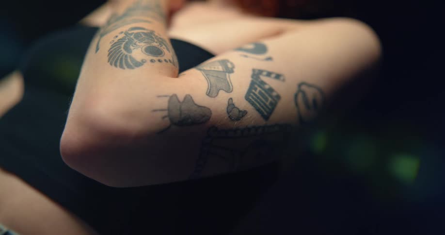 Close up of female models arms with tattoos in the studio