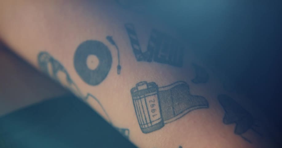 The person has tattoos all over their arm
