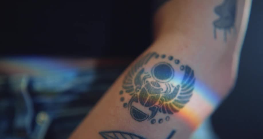 Close up of womans arm with tattoos in the studio