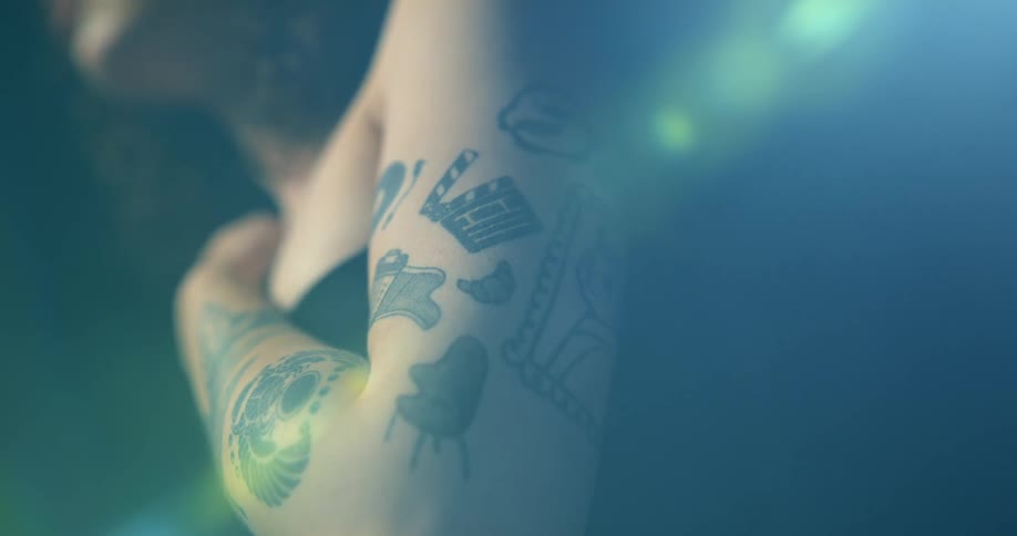 Close up of female models arm with tattoos in the studio