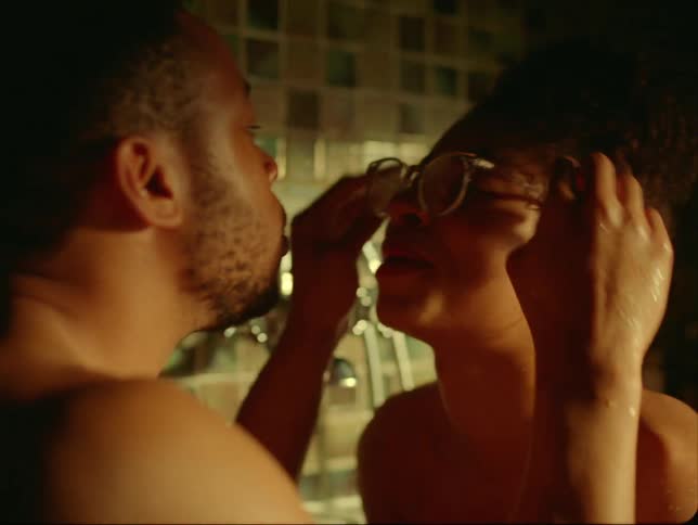 A man places glass on the face of his female companion while theyre together in a bathroom