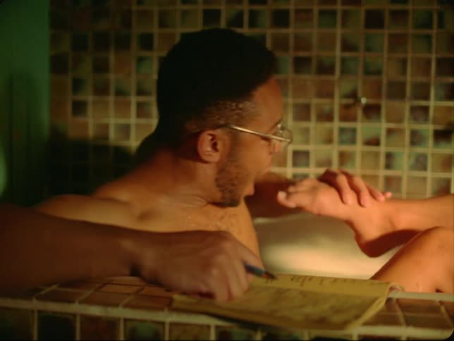 Man with glasses and woman take a bath and play with each other in the bathroom