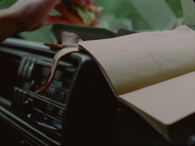 Close up of notebook on car dashboard