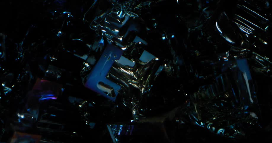 A light reflects off blue tones on a gemstone