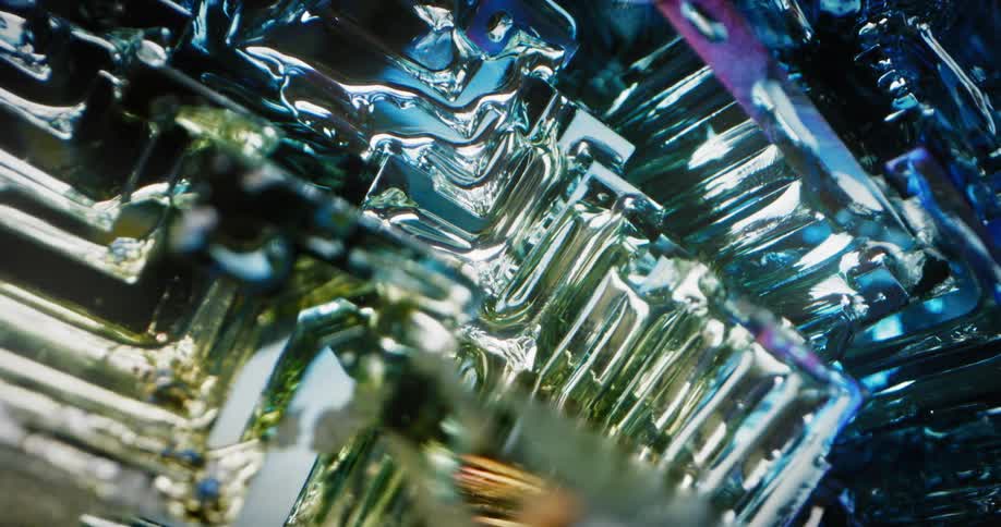 Light shines on the shiny reflective surface of an object with many dimensions and a blue highlight