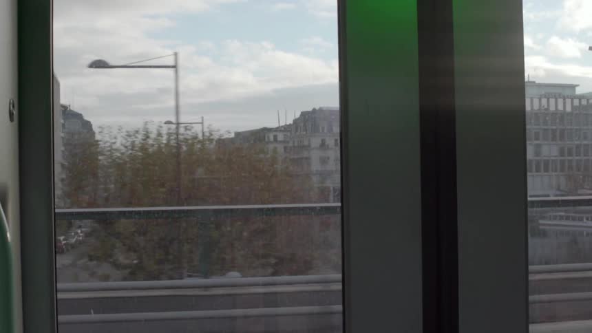 Looking out of a train window a city passes by
