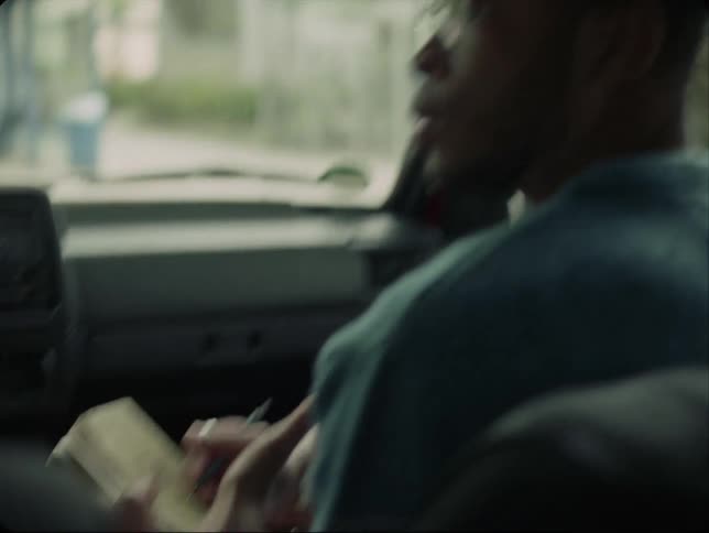 A man stares at his partner yelling at him while she drives