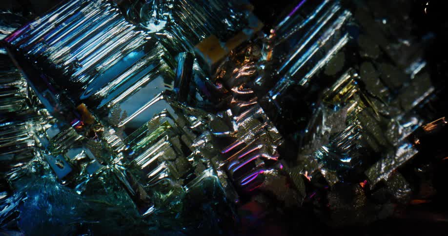 Light and shadow play over surface of boxing crystals tipped with silver