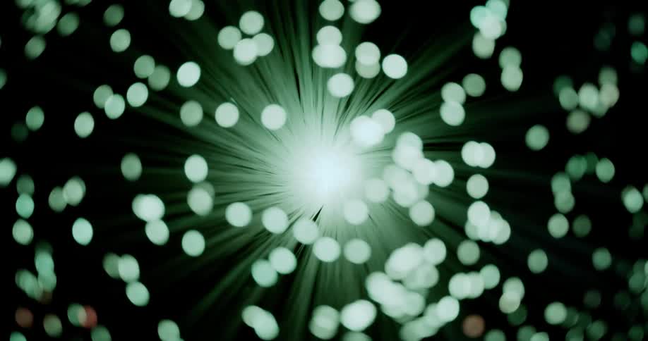 A number of small colorful lights emit from a bundle of fiber optic filaments