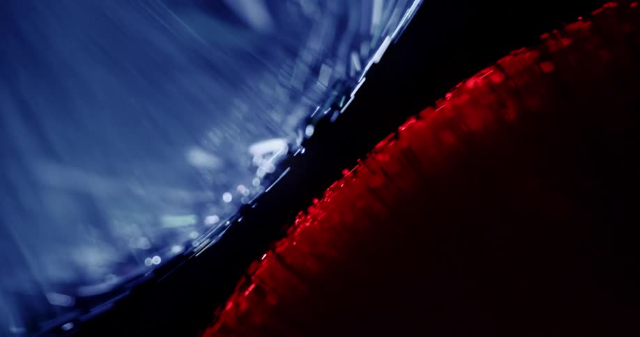 Blue light orbs spinning over red light orbs