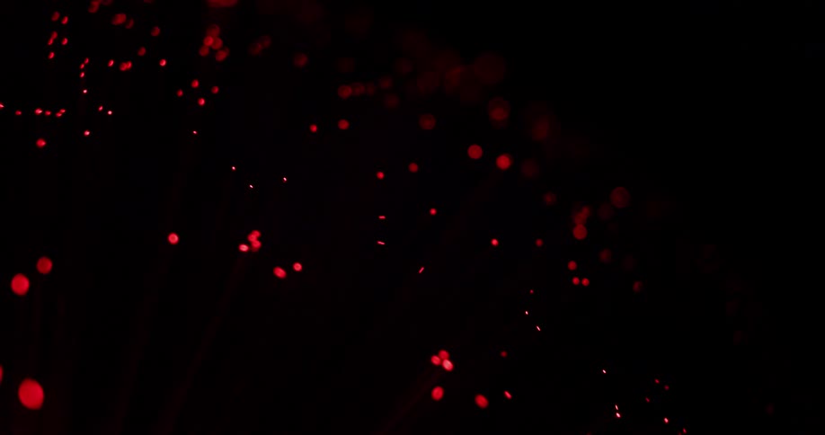 Glowing spots in various shades of red bob and weave