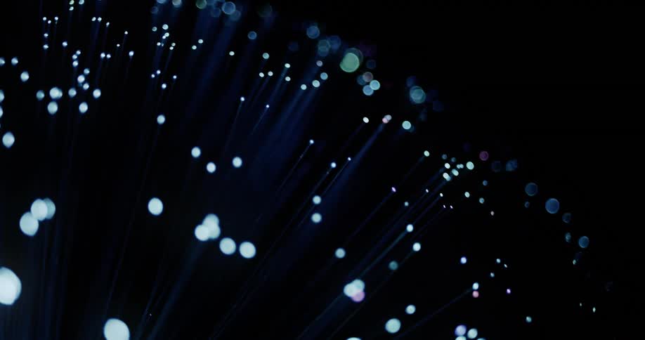 Lighted ends of waving filaments change between blue and green in dark area