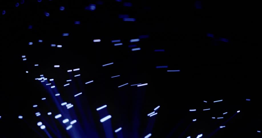 Bright blue filaments and the dots at their tips wave in the blackness