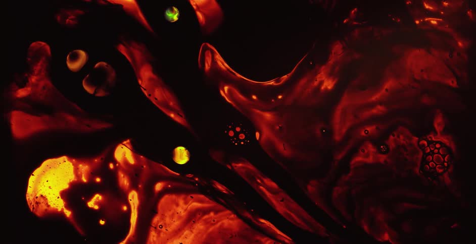 Close up of red and black liquid flowing and swirling