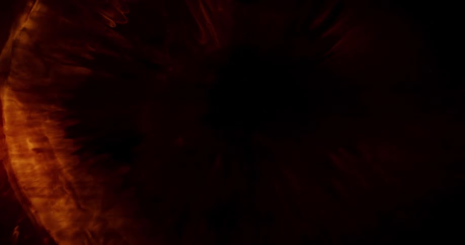 A viscous orange liquid spreads outward