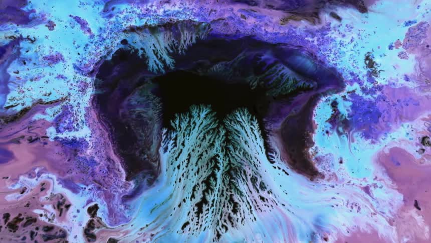 Light blue and lavender colors spread and merge into the black center area